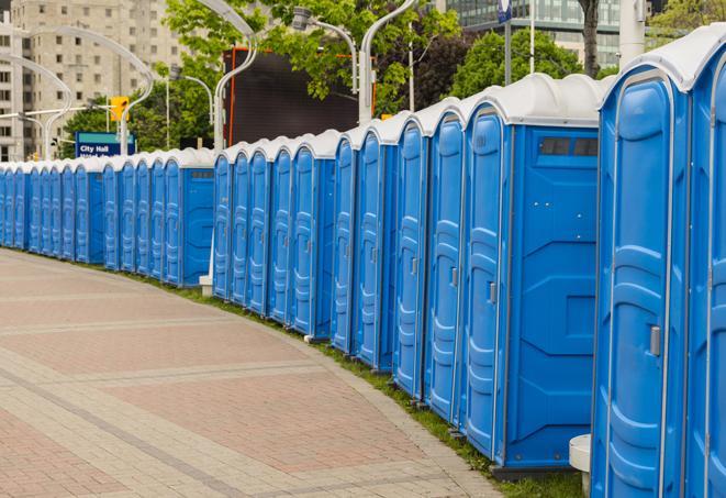 a line of portable restrooms at a sporting event, providing athletes and spectators with clean and accessible facilities in Bingham Farms